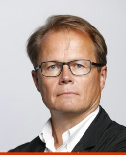 Heikki Mäkijärvi in a suit and glasses